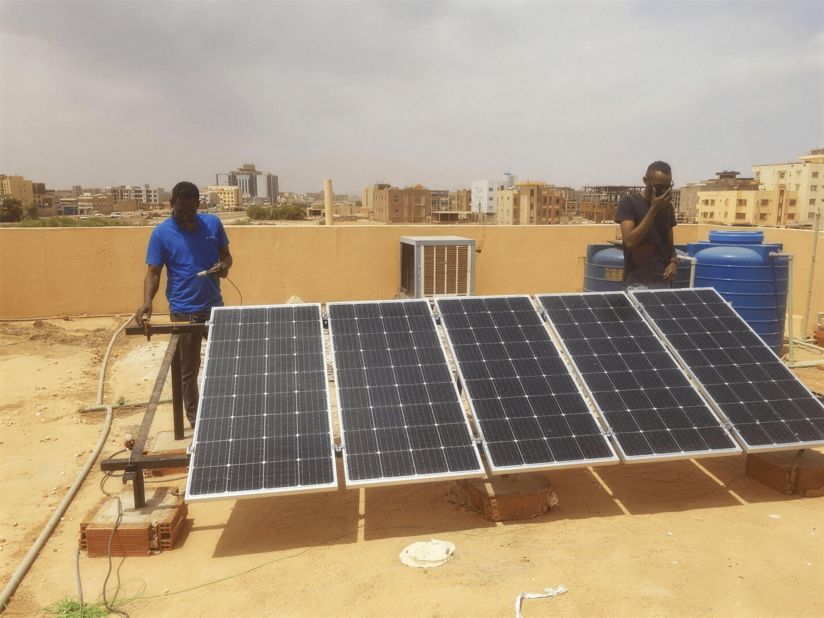 Saruest installers commissioning a rooftop array in Khartoum